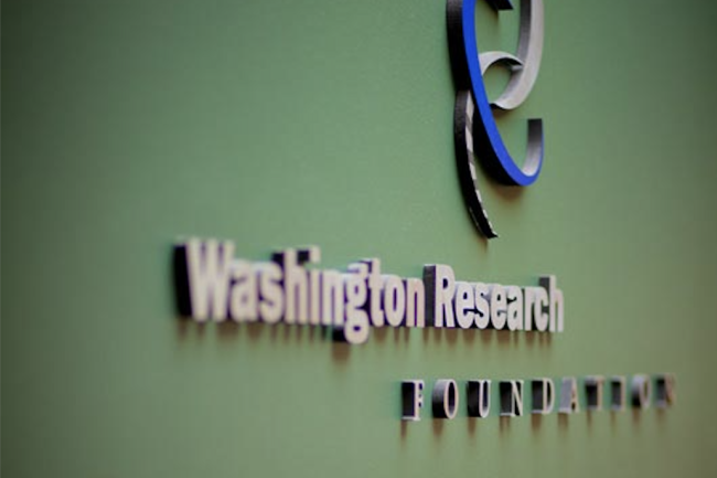A photo of the Washington Research Foundation sign and logo on a green background.