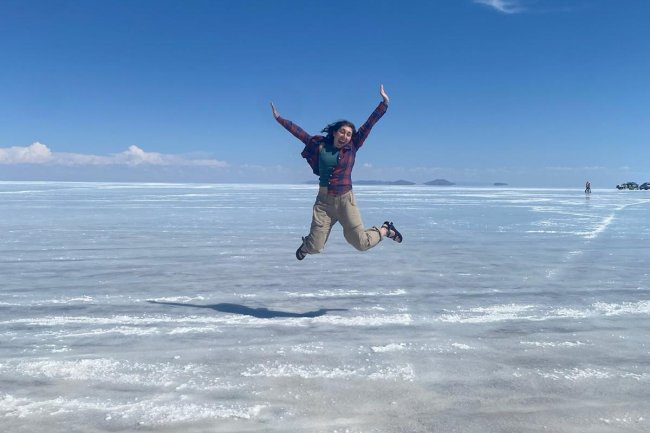 A student jumps into the air at a dry salt flat in Bolivia