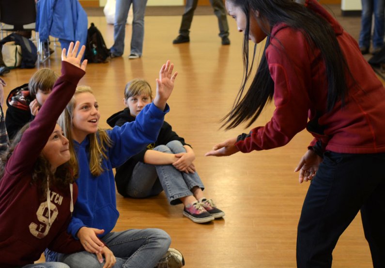 Assistant Director of Admissions Janis Farmer asks Whatcom Middle School students Aly Langer, left, and Catlyn Stevenson what they know about college inside the Viking Union Multipurpose Room during a tour of the Western Washington University campus Thurs