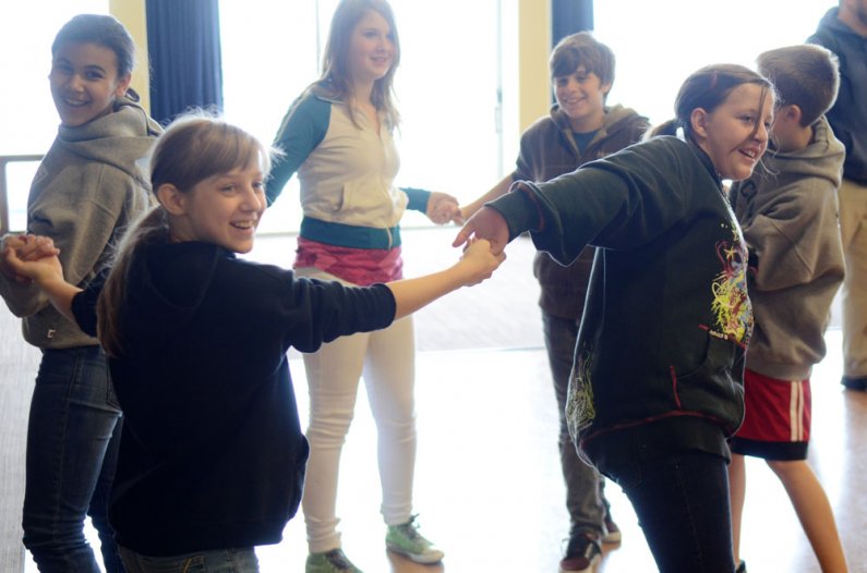 Students from Whatcom Middle School smile as they do an exercise to get themselves turned the other way during a tour of the Western Washington University campus Thursday, May 26. The tour  was a collaboration with the Woodring College of Education. Photo
