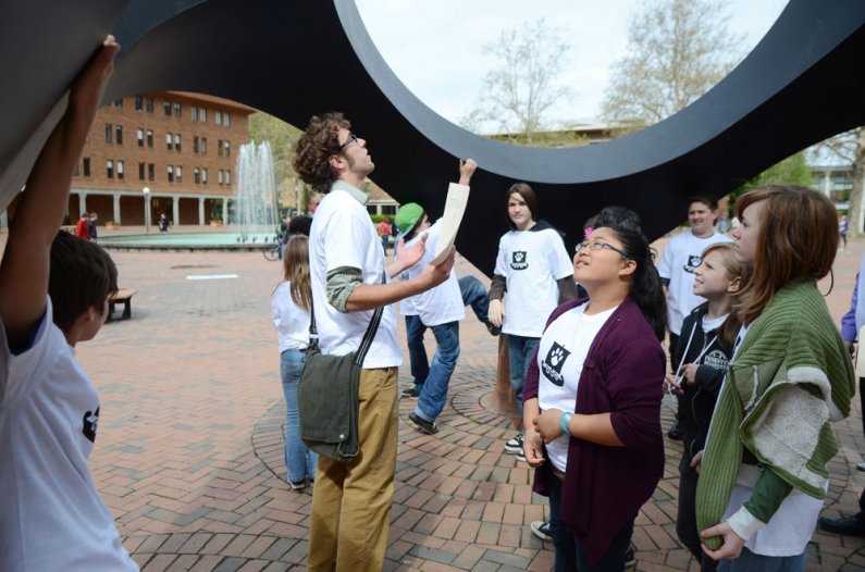 Students from Whatcom Middle School learn about Isamu Noguchi's Skyviewing Sculpture in Red Square during a tour of the Western Washington University campus Thursday, May 26, as part of a collaboration with the Woodring College of Education. Photo by Dani