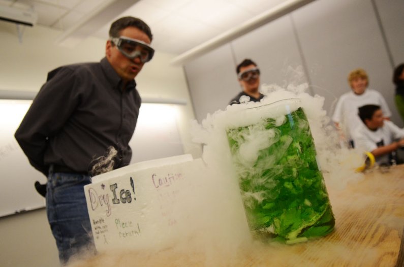 WWU chemistry instructor Mark Peyron, left, works with dry ice as chemistry major Michelle Marsura and Whatcom Middle School students look on during the science experiment part of a tour of the Western Washington University campus Thursday, May 26. The to