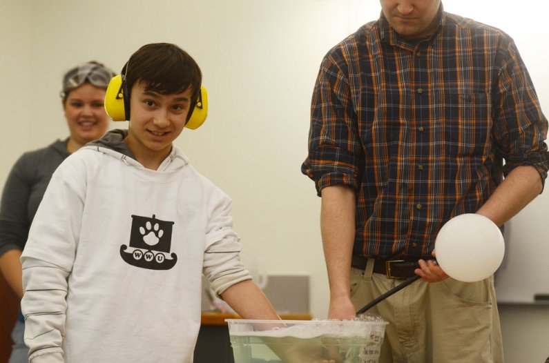 Whatcom Middle School student Nathan Whetnall, 12, reacts to adjunct professor Chuck Schelle's statement "this experiment only goes wrong one out of every three times," while participating in the science experiment part of a tour of the Western Washington
