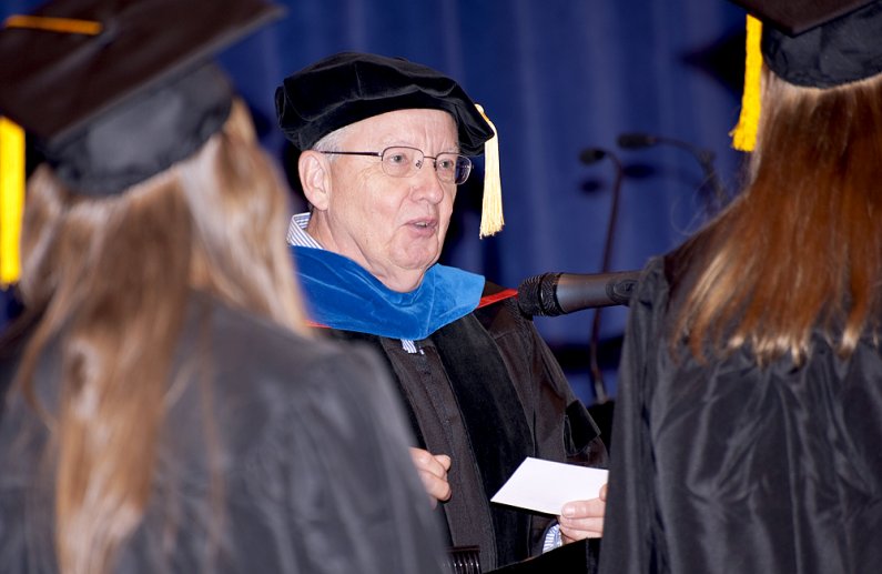 Arlan Norman, who recently retired as dean of the College of Sciences and Technology at Western Washington University, reads for the last time the names of graduates from CST at summer commencement on Saturday, Aug. 20, 2011. Photo by Tore Ofteness for WW