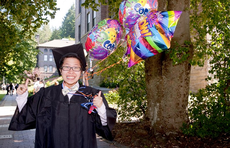 Graduating student Dung Pham poses for a photo in front of Old Main on the Western Washington University campus Saturday, Aug. 20. Photo by Tore Ofteness for WWU