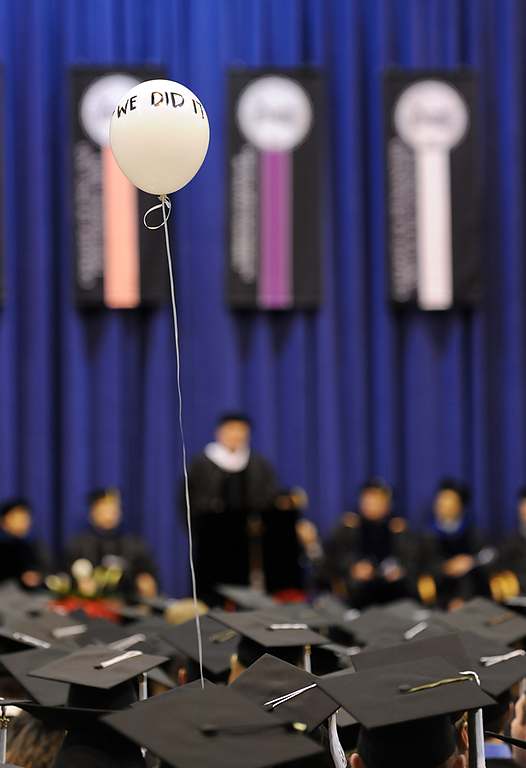 Mahogany Villars holds a ballon that says "We Did It" while waiting to receive her diploma during the fall 2009 commencement at WWU on Dec. 12, 2009. Photo by Rachel Bayne