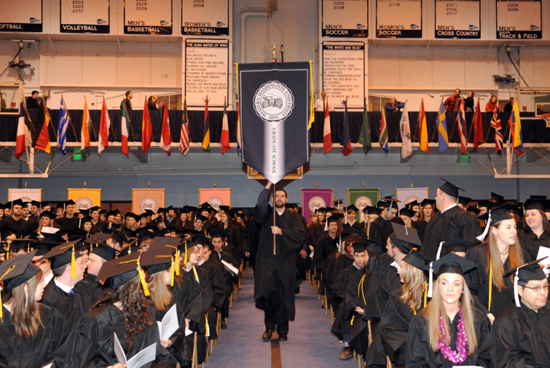 The various banners are brought to the front of the gymnasium during fall 2009 commencement. Photo by Rachel Bayne