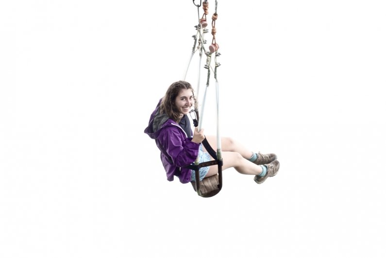 A student appears to float in the clouds as they ride the Swing at the End of the World at the Casa del Arbol in Baños.