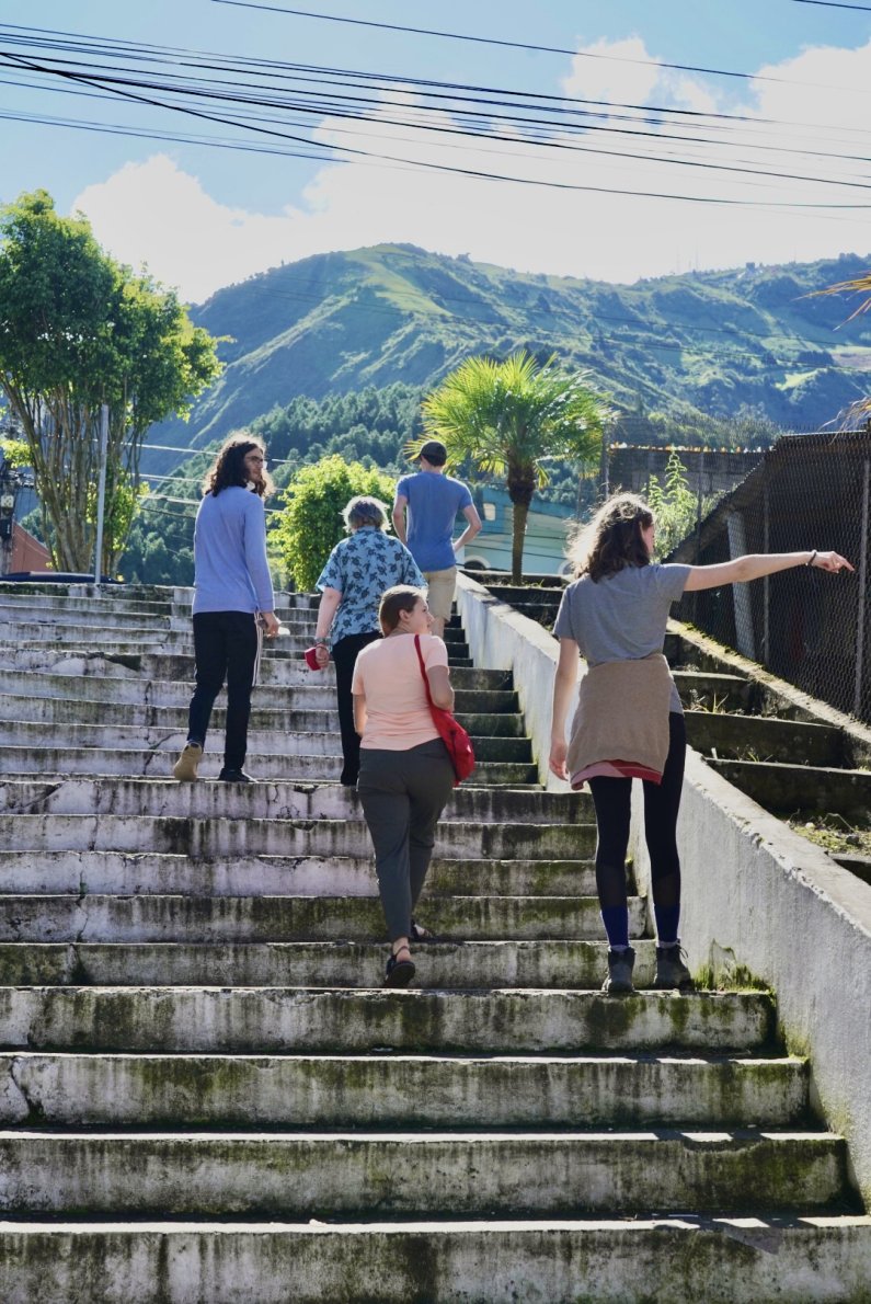 Students walk up the steps as they explore the city of Baños.