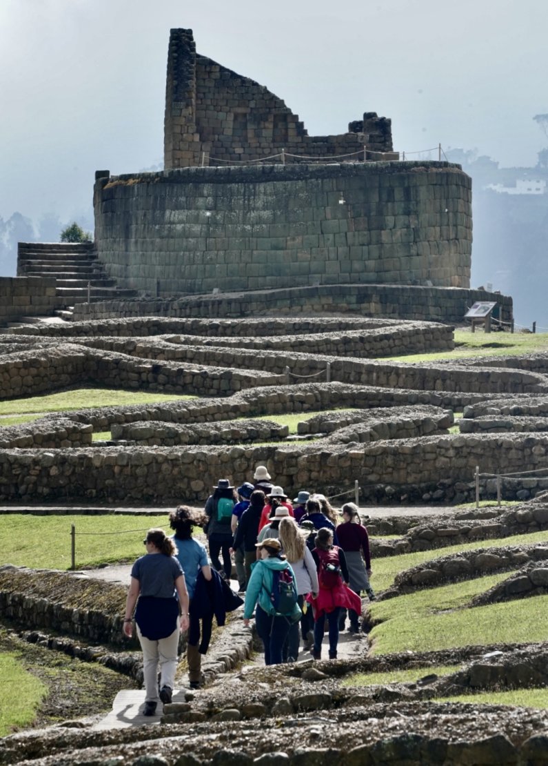 Students walk among the ancient stone walls of Ingapirca toward the Temple of the Sun.