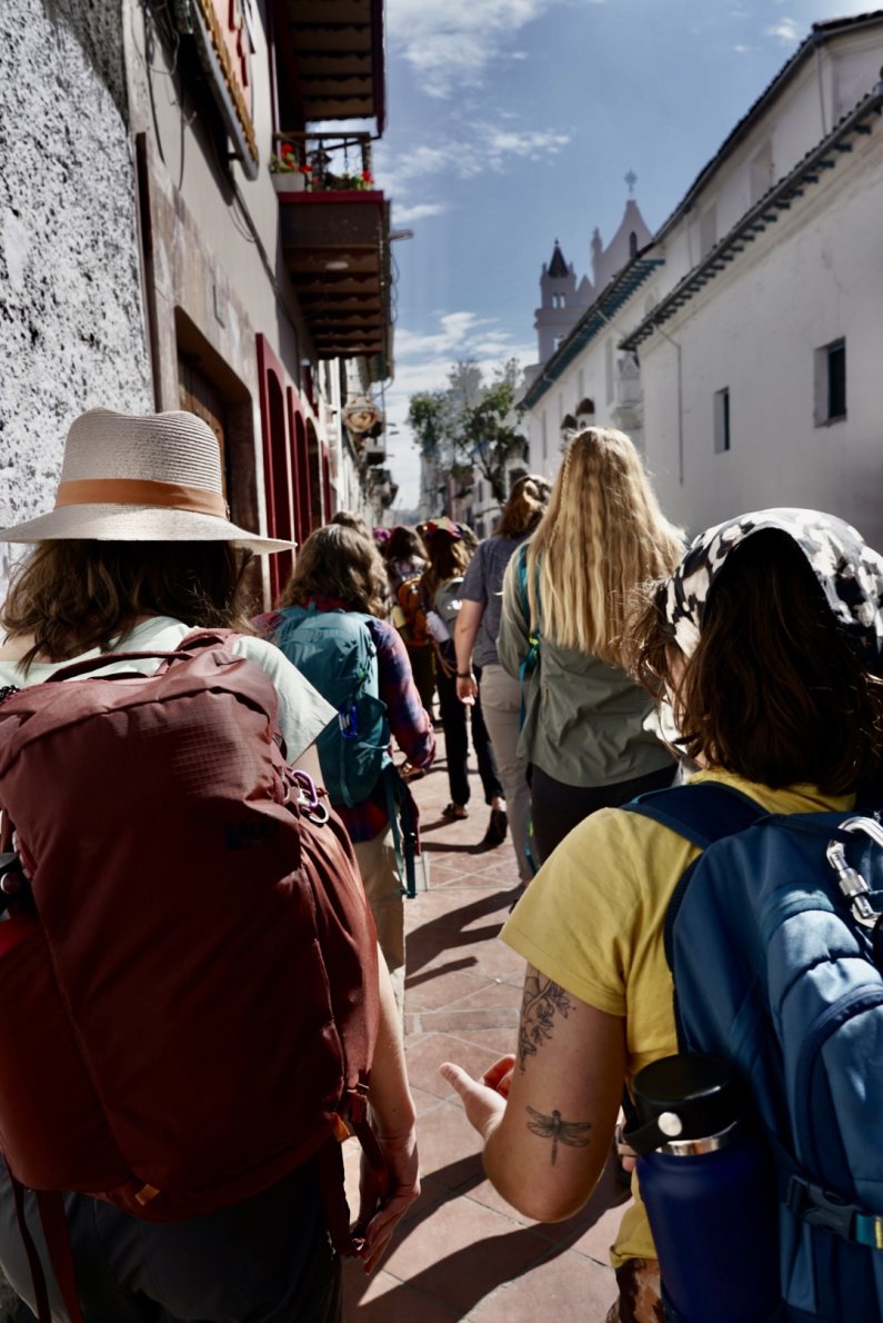 Students walk along the sidewalk as they explore the city of Cuenca.