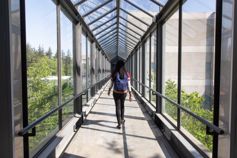 Martha Torujo, a senior biochemistry major, walks through the sky bridge, located on the fourth floor connecting the chemistry and biology buildings.