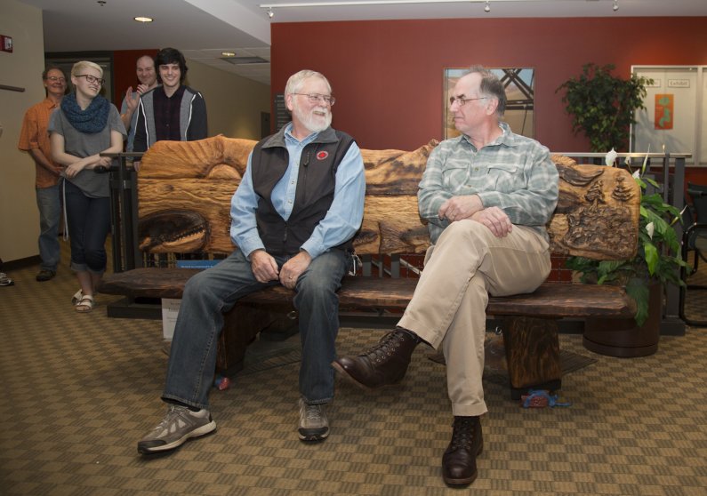 Jim Schuster and Kevin Majkut, both recently retired from Viking Union administration at Western Washington University, returned to the VU Monday to be presented with a hand-carved bench made in their honor. Courtesy photo.