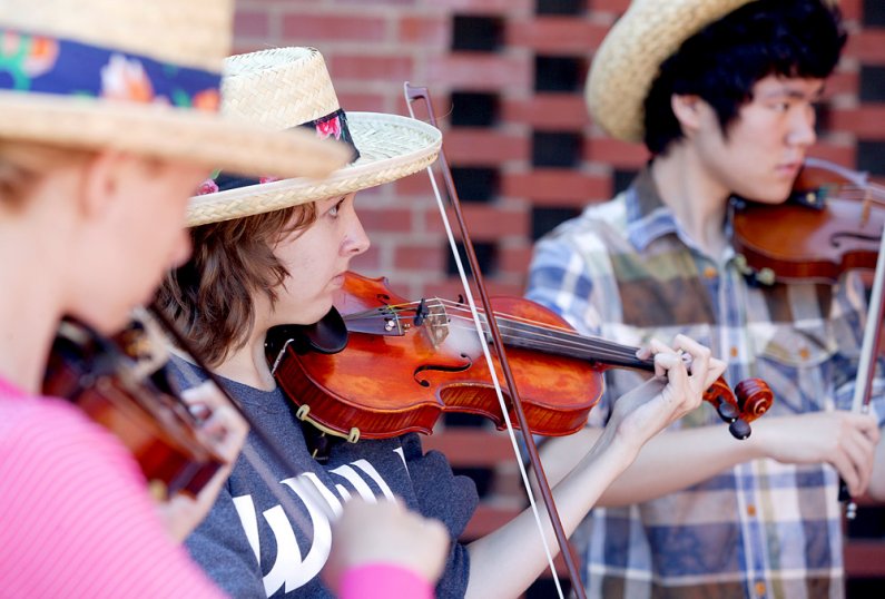 Carley Small, from Mill Creek, practices her violin for a Sunday concert as part of the Marrowstone Music Festival at Western Washington University. Small is flanked by Frances Larsen, left, from Anchorage, Alaska, and Bellevue's Minky Kim. Photo by Matth