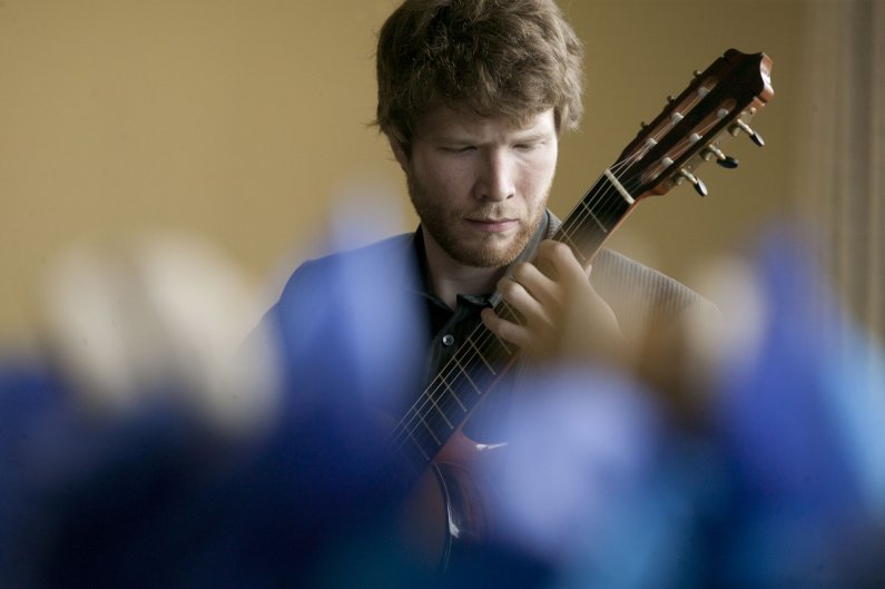 WWU senior John Zientek performs at the College Success Foundation luncheon June 10 as guests arrive and are seated. Photo by Matthew Anderson | WWU