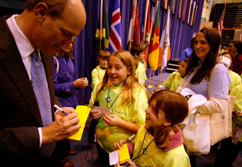 U.S. Rep. Rick Larsen signs autographs after speaking to the 900 fifth graders on hand for the Compass 2 Campus opening ceremony Oct. 26. Photo by Matthew Anderson | WWU