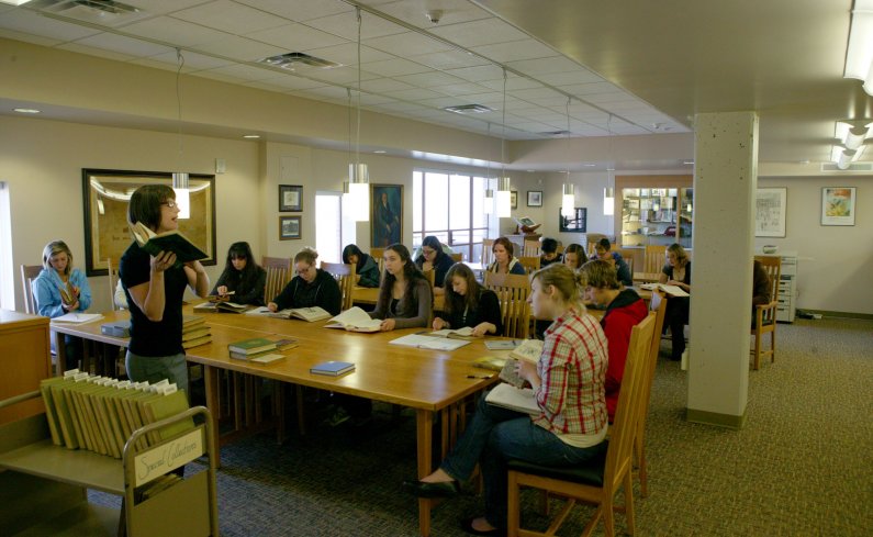 Kristen Mahoney, an assistant professor of English at Western Washington University, leads students in a study session in Wilson Library's Special Collections on Sept. 30. Photo by Matthew Anderson | University Communications