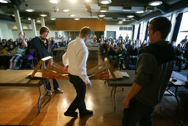 Western Washington University student Jacob Newer-Thurber, left, reacts as the bridge he built with Alex Dehn, right, and other teammates holds the weight of the test truck during a bridge-building competition on the WWU campus Oct. 19, 2010. Photo by Mat
