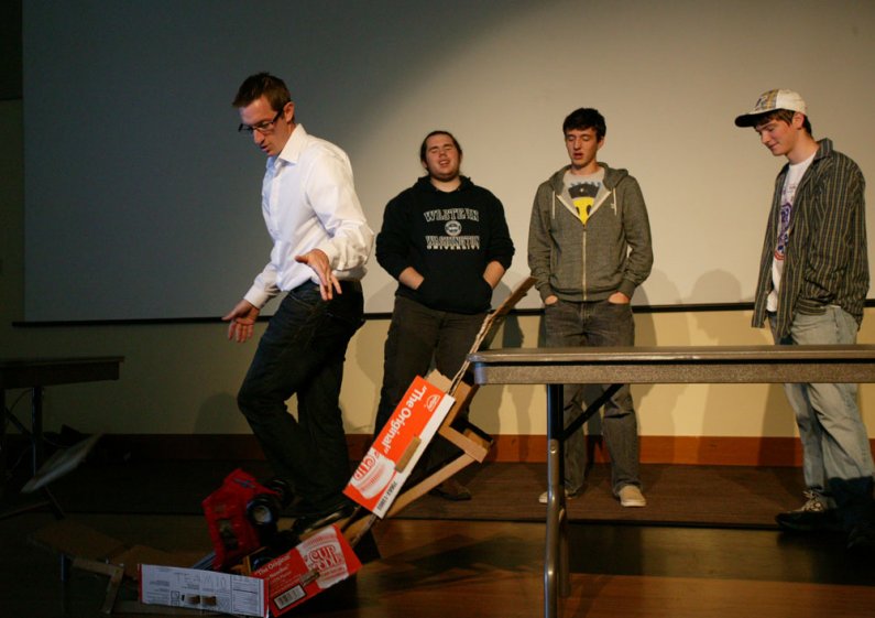 WWU students Colin Wooten, Chris Holland and Zach Uhrich react as their bridge collapses during the bridge-building competition on Oct. 19, 2010, in the Viking Union Multipurpose Room. Photo by Matthew Anderson | University Communications