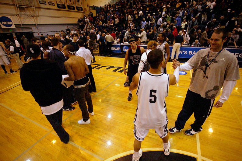WWU players, including senior Derrick Webb, celebrate on the court after a hard-fought 84-70 victory over arch-rival Central Washington University Friday, March 12. WWU opened up a 20-point first-half lead only to see it vanish in the second half after a 