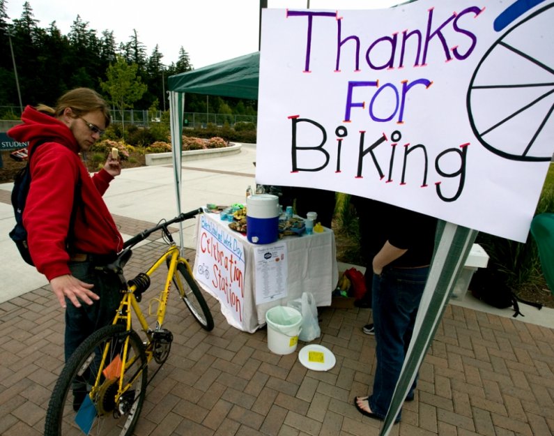 WWU student Zach Snover talks about his bike at the Bike to Work and School Day celebration station set up near the Wade King Student Recreation Center on campus Friday, May 21. Photo by Matthew Anderson | WWU