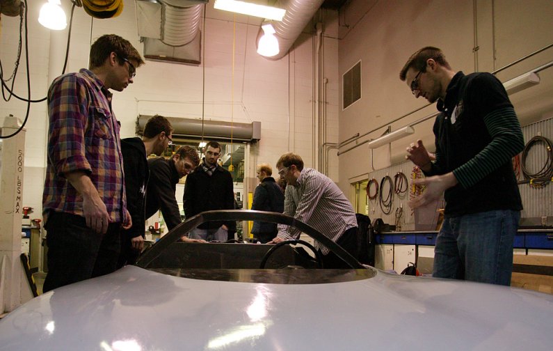 WWU students Tyler Schmid, left, and Sam Cullison talk about Viking 45, the car that the VRI has entered in the Progressive Automotive X-Prize competition. The students plan to have the car up and running by the end of the month. Photo by Matthew Anderson