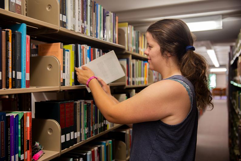 Western Senior Ashley Koeffler looking for a book in Wilson Library on August 6, 2019. 
