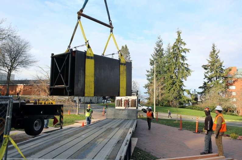 The 'Untitled' sculpture by Donald Judd, which has sat on the Old Main lawn since its installation there in 1983, is loaded to a flatbed truck Thursday morning, Dec. 5, in preparation for a move to Seattle for restoration and eventual resiting on south ca