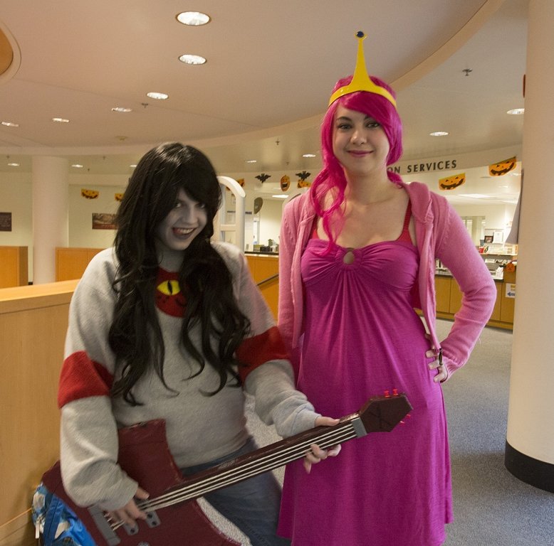 Western students Jenna Montgomery, left, and Rachel Wright pose in Wilson Library on Wednesday, Oct. 31, as characters from animated television series “Adventure Time.” They both put together their clothes from home, except for Wright’s pink wig, which sh