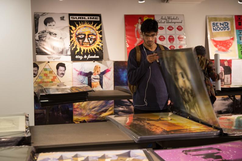 Srvejm Chaudhau browses through posters on the final day of the back to school poster sale in the Viking Union Gallery on. Sept 27.