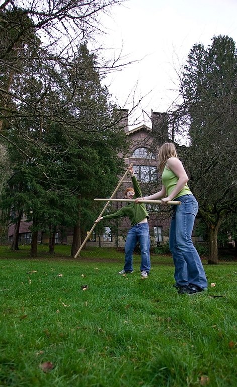 Members of the Western Washington Fencing Club, Alyssa Bangs and William Hongland, practice combat with quarterstaffs outside Old Main on Tuesday, Feb. 2, after recently receiving instructions from Fencing Maestro Michael Allen. Photo by Jon Bergman | Uni
