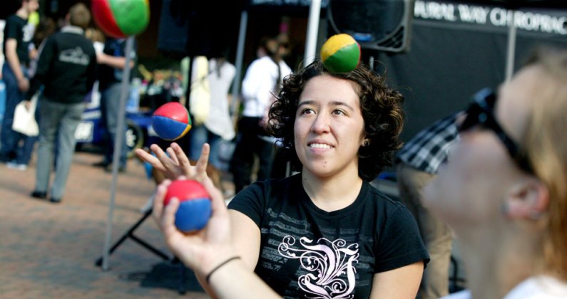 Alexandra Vasquez, a member of the Circus Skills Society at Western Washington University, juggles along with fellow club member Kelsey Gauche', right, at the Red Square Info Fair on Tuesday, Sept. 21, 2010. Photo by Matthew Anderson | University Communic