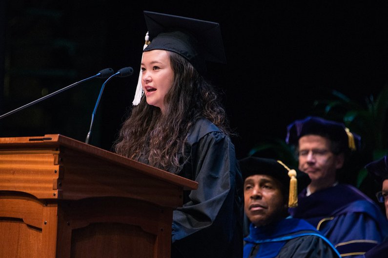 Lani Asman (Bachelor of Arts, Interdisciplinary Concentration, and Bachelor of Science, Mathematics) addresses her fellow graduates during ceremony one.