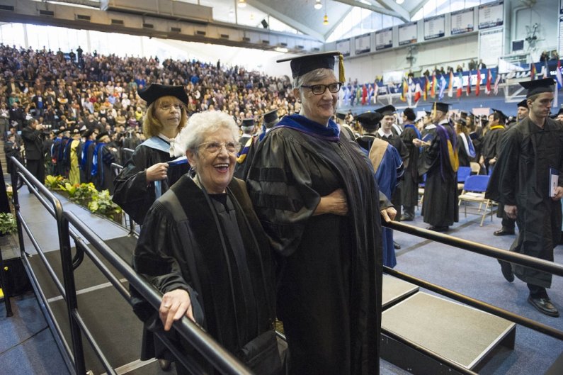 Holocaust survivor Noémi Ban, an award-winning public speaker and teacher, walks with WWU Provost Catherine Riordan at Western Washington University's commencement on March 23, 2013. Ban delivered the commencement address and was given an honorary doctora