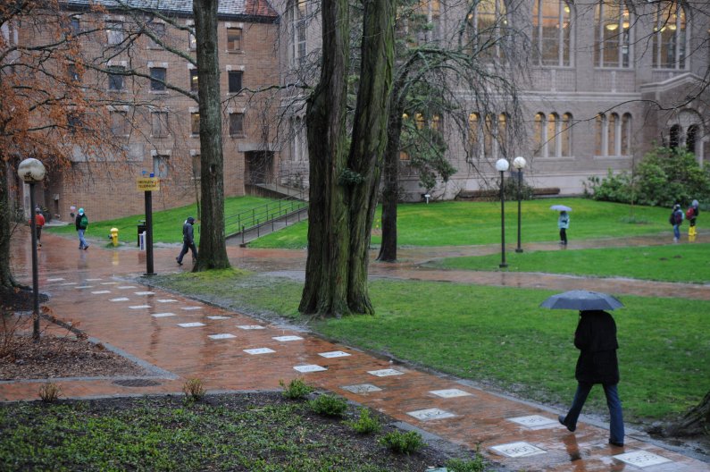 Western students walk past Old Main through heavy rain on a dark day Wednesday, March 30, 2011. Photo by Daniel Berman | University Communications intern