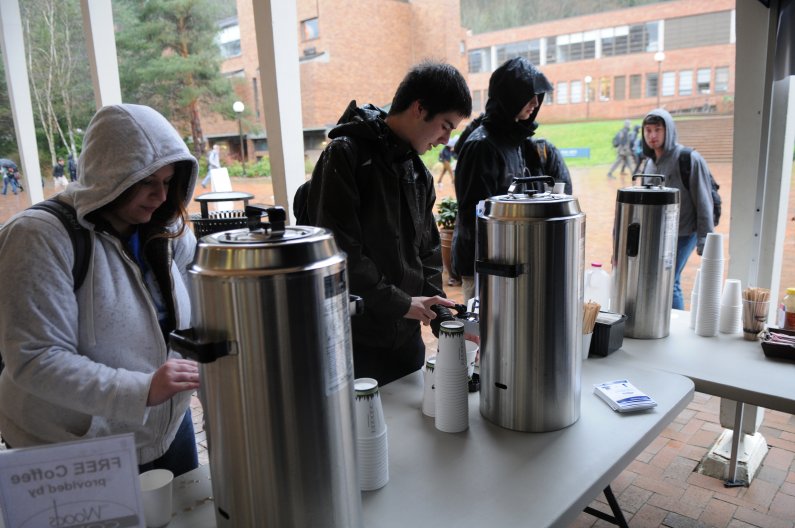 As rain falls, students grab cups of free coffee provided by The Woods Coffee and Western on a dark day Wednesday, March 30, 2011. Photo by Daniel Berman | University Communications intern