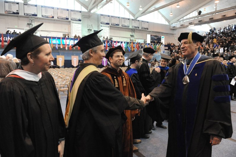 WWU President Bruce Shepard shakes hands with Paul Piper, from the Western Libraries, during the March 19 commencement exercises on campus. Photo by Dan Levine