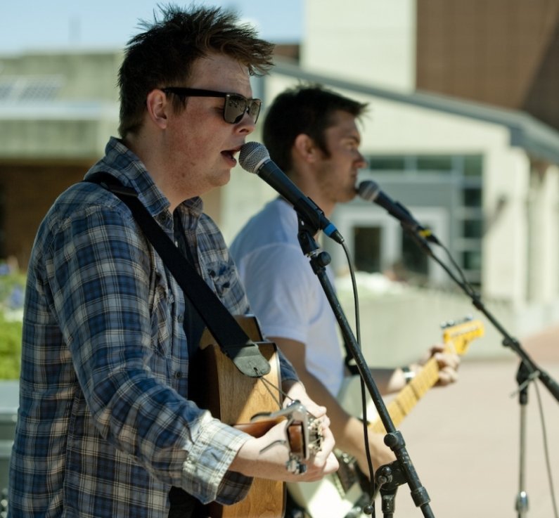 Washington Mile lead singer Chris Wise, 25, and lead guitarist Mark Wolter, 24, sing and play guitar for the audience during Western Washington University's Summer Noon Concert series on Wednesday, July 7, 2010, in the Performing Arts Center Plaza on camp