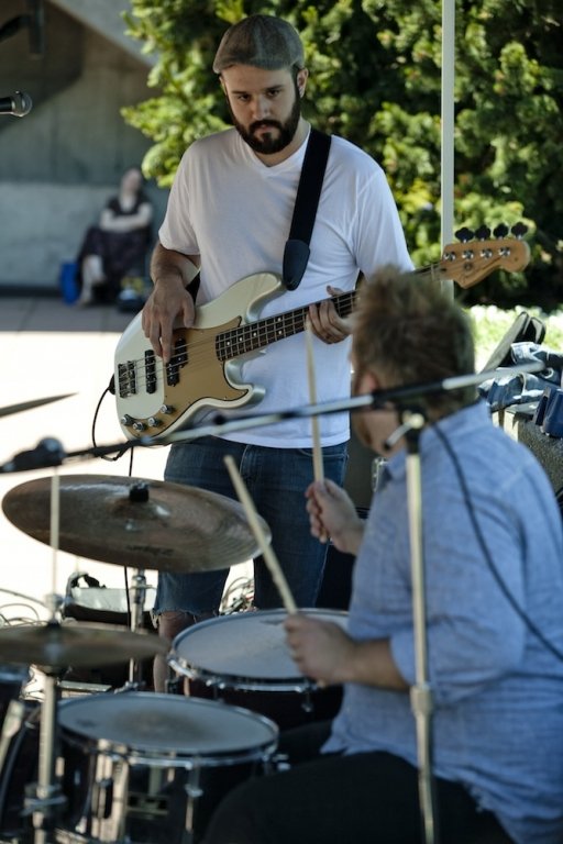 Washington Mile drummer Brandon Shuman, 26, and bassist Sean Gasperetti, 26, exchange glances to sync up the timing of the drums and bass during Western Washington University's Summer Noon Concert series on Wednesday, July 7, 2010, in the Performing Arts 
