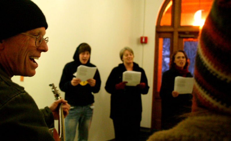 Members of the WWU singing group FM Singers, including WWU electrician Fred Escher, left, fill the hallways of Old Main on Wednesday, Dec. 16, with Christmas carols. Photo by Matthew Anderson | WWU
