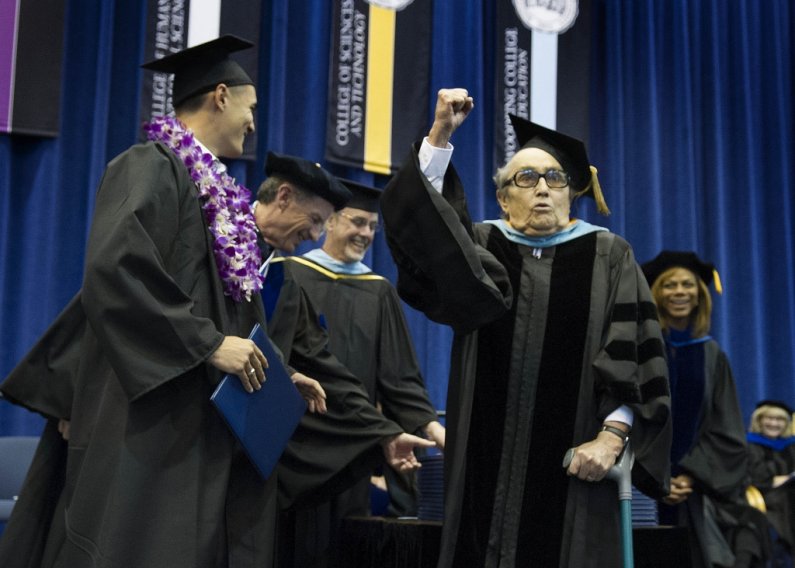 Former Western Washington University President Jerry Flora celebrates after presenting a diploma to his grandson, Addeson Moh. Photo by Dan Levine | for WWU