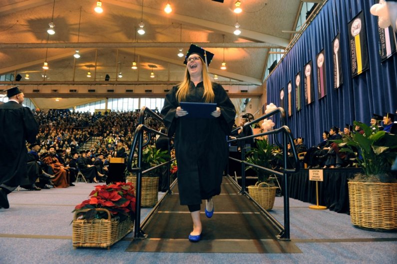 New graduate Megan Runkel celebrates after walking across the stage. Photo by Daniel L. Levine | for WWU