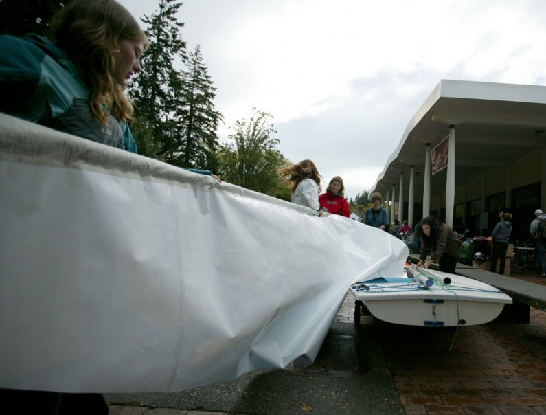 Western Washington University student Angela Gossom, left, helps fold up a sail advertising WWU's Lakewood facility after the first day of the Red Square Info Fair on Sept. 20, 2010, in front of the Viking Union Multipurpose Room on campus. Helping her ar