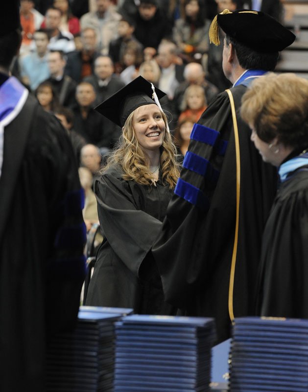 Elizabeth Carter shakes hands with WWU President Bruce Shepard as she receives her diploma at the March 19 commencement ceremony. Photo by Dan Levine