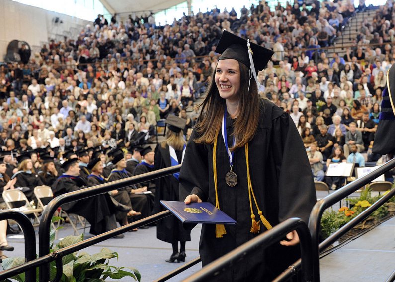 Amy Grambo, a Presidential Scholar from Woodring College of Education, receives her diploma at WWU commencement exercises Saturday, June 11, in Carver Gymnasium on campus. Photo by Dan Levine | for WWU