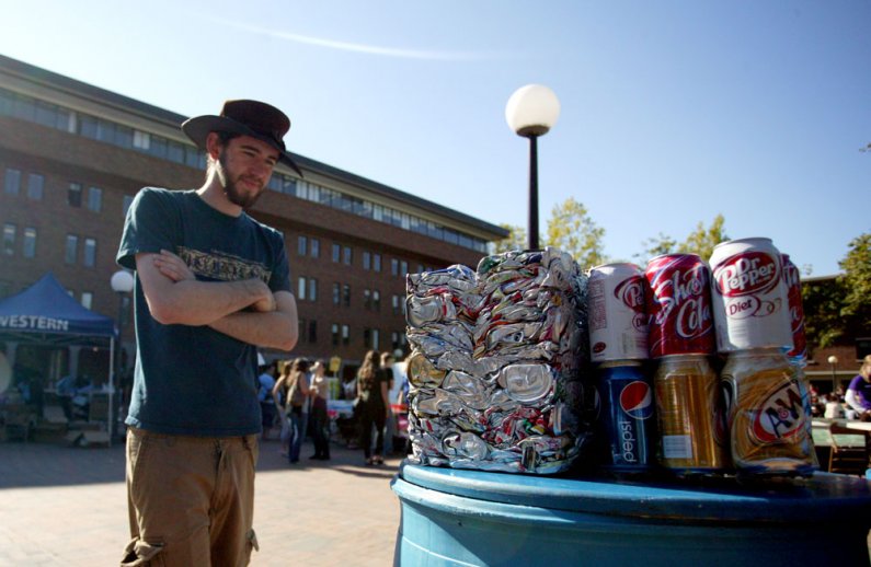 Western Washington University senior Philip Robinson tries to guess how many soda cans are in a crushed block of aluminum at a booth set up by the AS Recycle Center at the Red Square Info Fair on Sept. 21, 2010. The block contains roughly 850 cans. Photo 