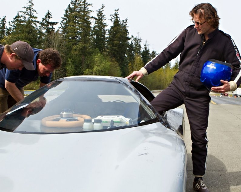 (Left to right) Kyle Foley and Mark Dudzinski check Viking 45's systems as Professor Eric Leonhardt climbs into the cab of the car for his laps around the track. Photo by Jon Bergman | University Communications intern