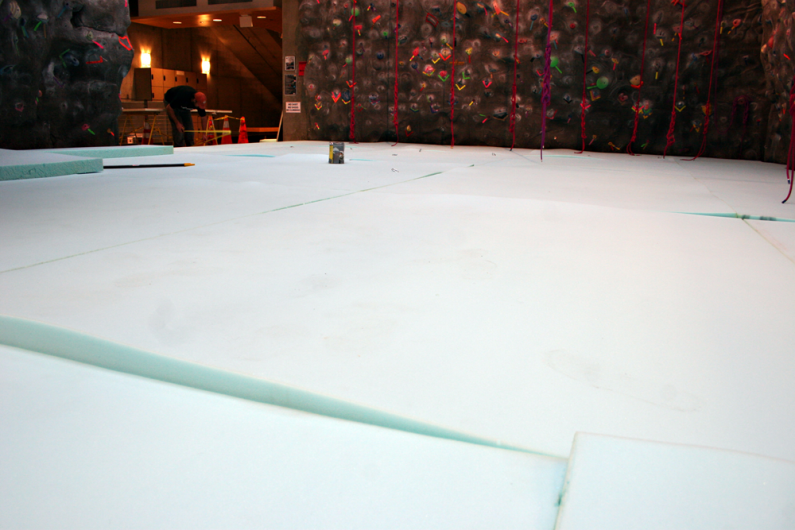 Workers installed a new padded floor under the climbing wall in the Wade King Student Recreation Center on Friday, Oct. 23. The installation is an attempt to diminish injures from climbers falling onto inadequate padding. Photo by Michael Leese | WWU inte