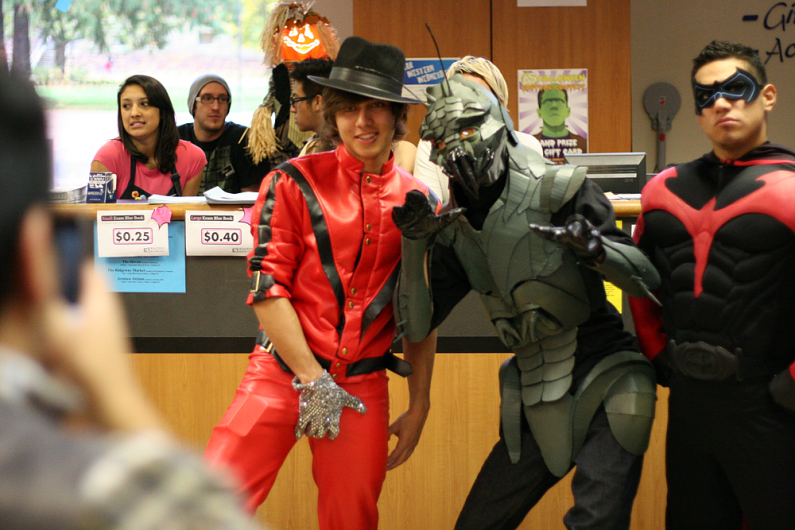 Three of the costume contest competitors pose for a photo in the Associated Students Bookstore Friday, Oct. 30. Ian Mayhew, in the middle, took first place for his "District 9" costume. Photo by Michael Leese | WWU intern