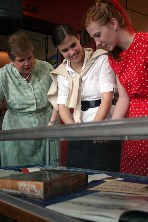 VU reservationist Linda Bolinger, left, looks at items from the 1959 time capsule alongside WWU students Cindy Monger, middle, and Amy Arms. Photo by Michael Leese | WWU intern